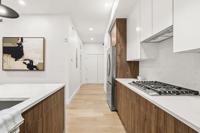 a kitchen with stainless steel appliances a sink a stove and a refrigerator