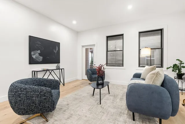 a living room with furniture a rug and a flat screen tv