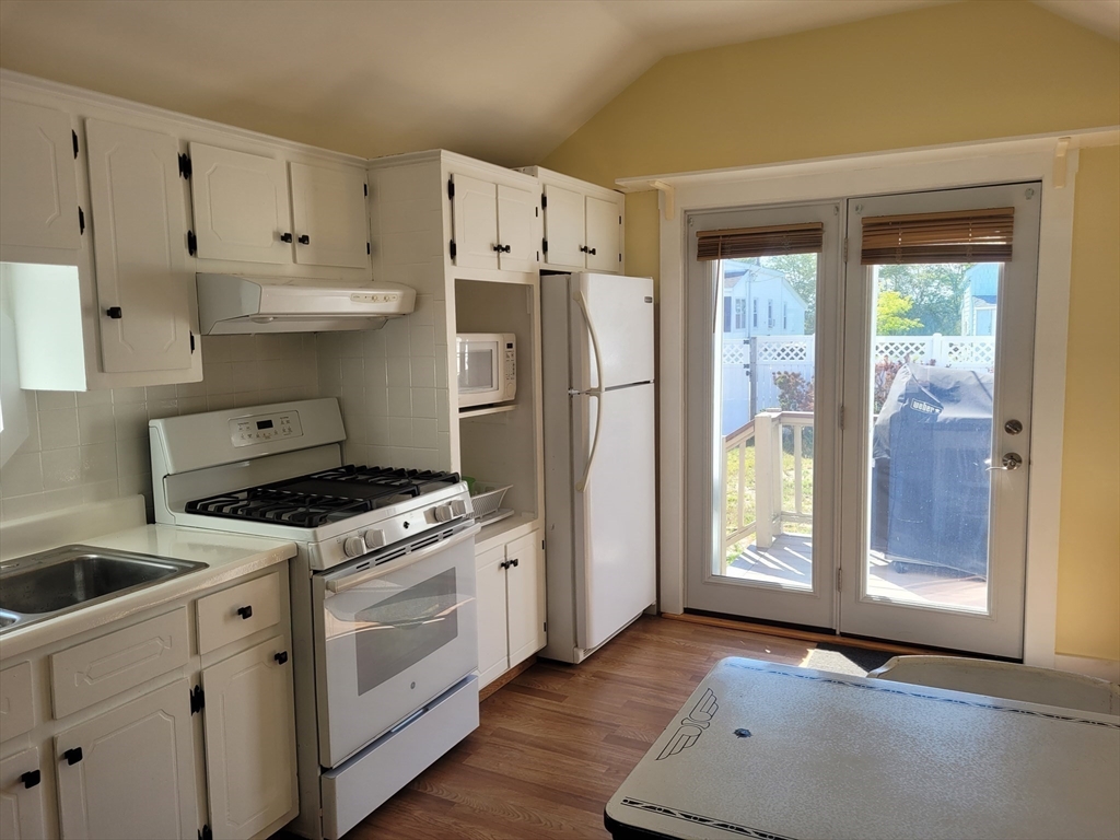 101 Cable Avenue Salisbury, MA 01952 - Photo 11 of 16 a kitchen with white cabinets and white appliances