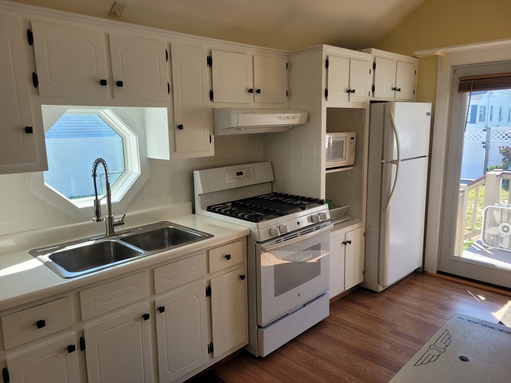 101 Cable Avenue Salisbury, MA 01952 - Photo 10 of 16 a kitchen with refrigerator a stove a sink and cabinets
