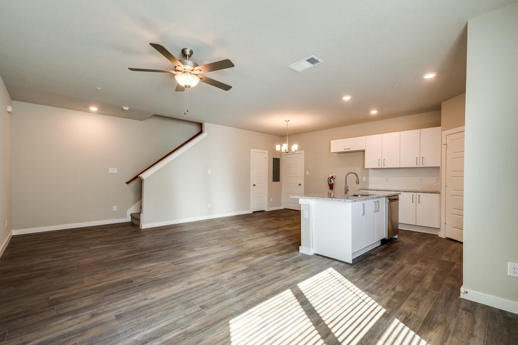 a view of a kitchen with wooden floor and a kitchen