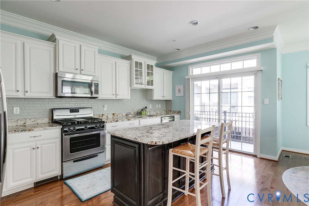 3900 Redbud Road Glen Allen, VA 23060 - Photo 13 of 37 a kitchen with stainless steel appliances granite countertop a stove a sink and a microwave