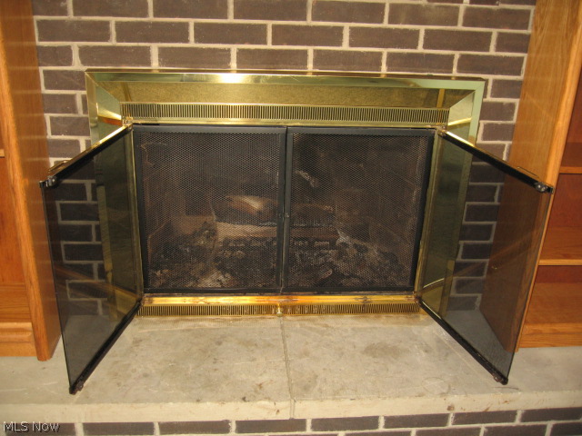 455 Broadview Road Tallmadge, OH 44278 - Photo 11 of 25 WOODBURNING FIREPLACE WITH BLT IN BOOKSHELVES TO LEFT AND RIGHT