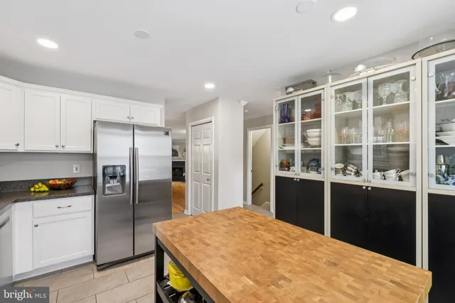 a kitchen with stainless steel appliances granite countertop a refrigerator stove microwave and sink