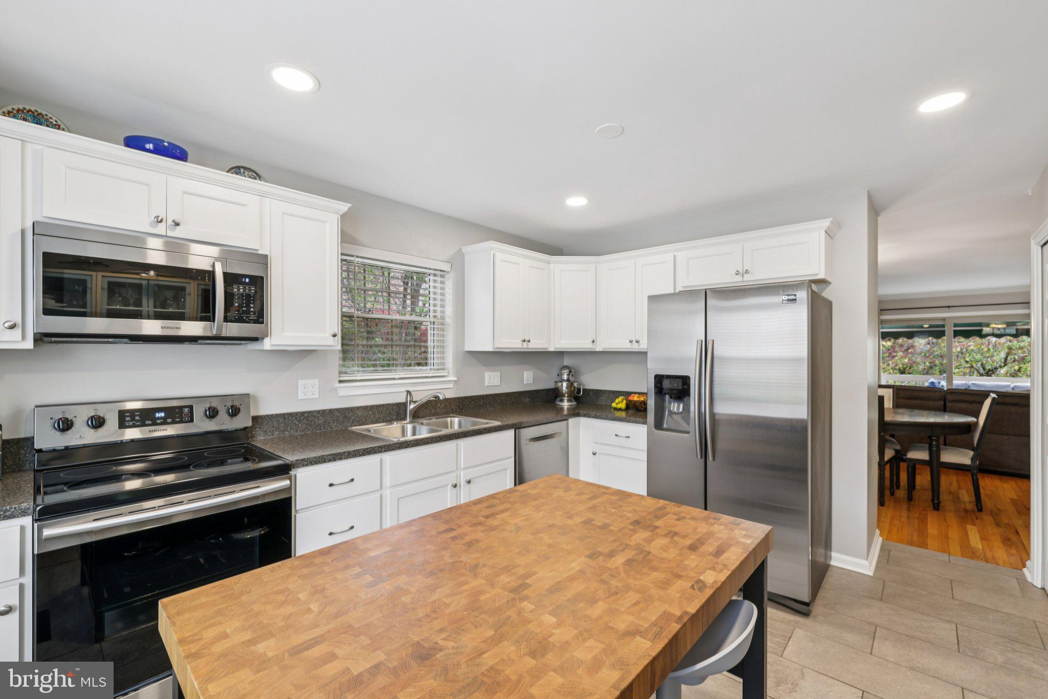 11 Old Forge Garth Sparks Glencoe, MD 21152 - Photo 12 of 39 a kitchen with stainless steel appliances granite countertop a refrigerator stove microwave and sink