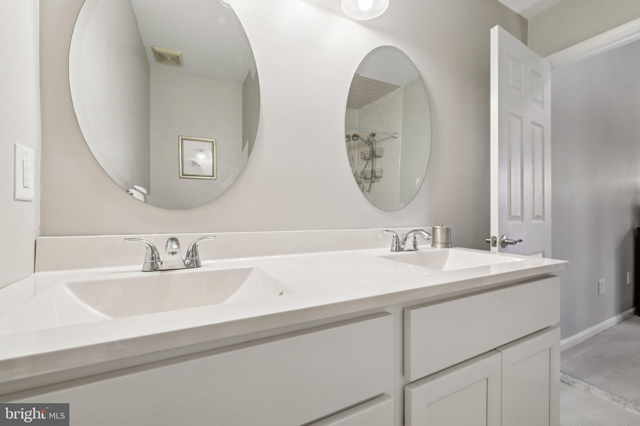 11 Old Forge Garth Sparks Glencoe, MD 21152 - Photo 15 of 39 a bathroom with a double vanity sink and a mirror