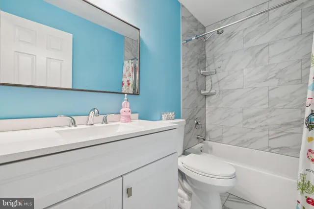a living room with furniture and a book shelf