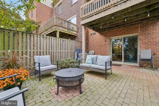 a backyard of a house with fountain table and chairs