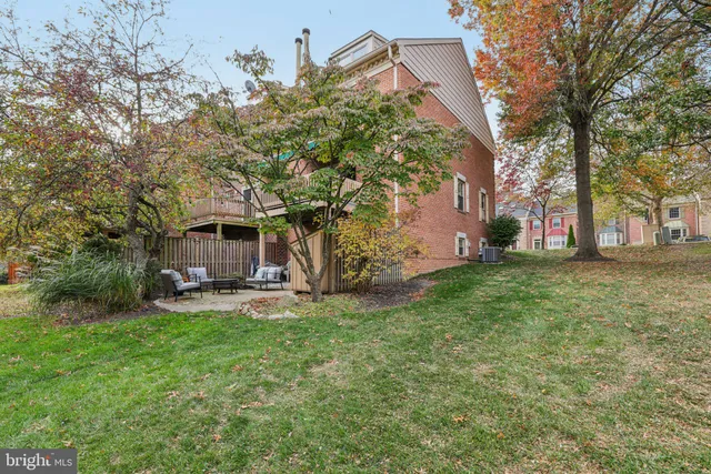 a view of a house with a yard and sitting area