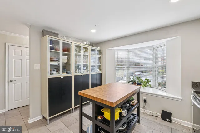 a kitchen with a stove a sink a microwave and cabinets