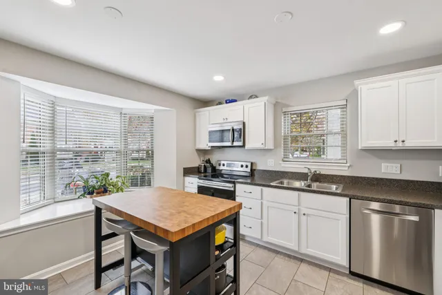 a kitchen with a refrigerator and a sink