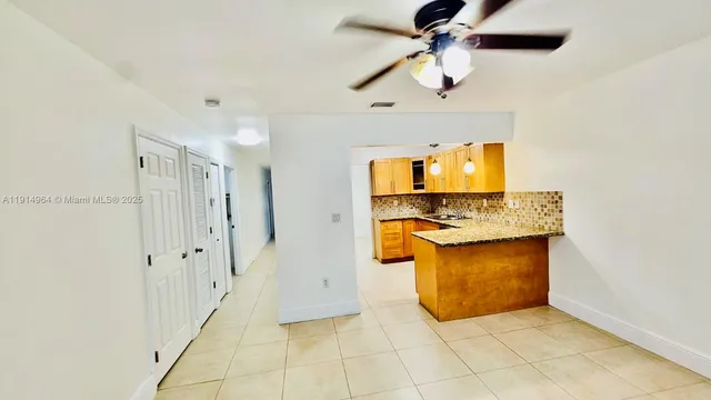 a view of a kitchen with a sink and a refrigerator