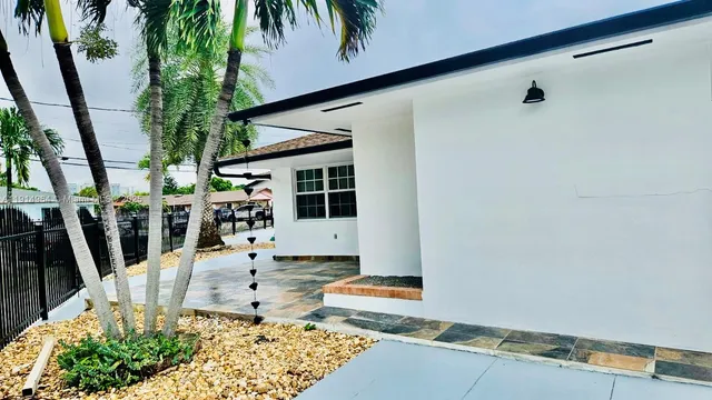 a view of residential house with stairs and wooden fence