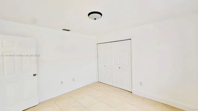 a view of a room with wooden floor and windows