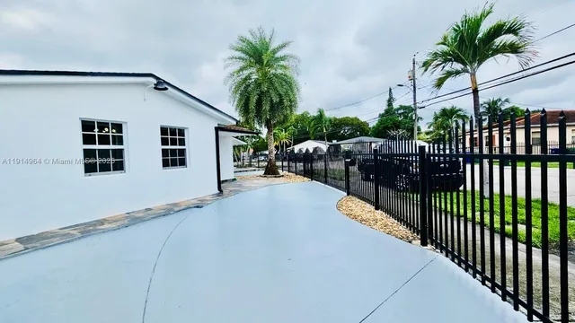 a view of a pathway of a house with wooden fence