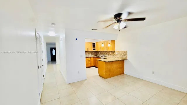 a view of a kitchen with a sink and a refrigerator