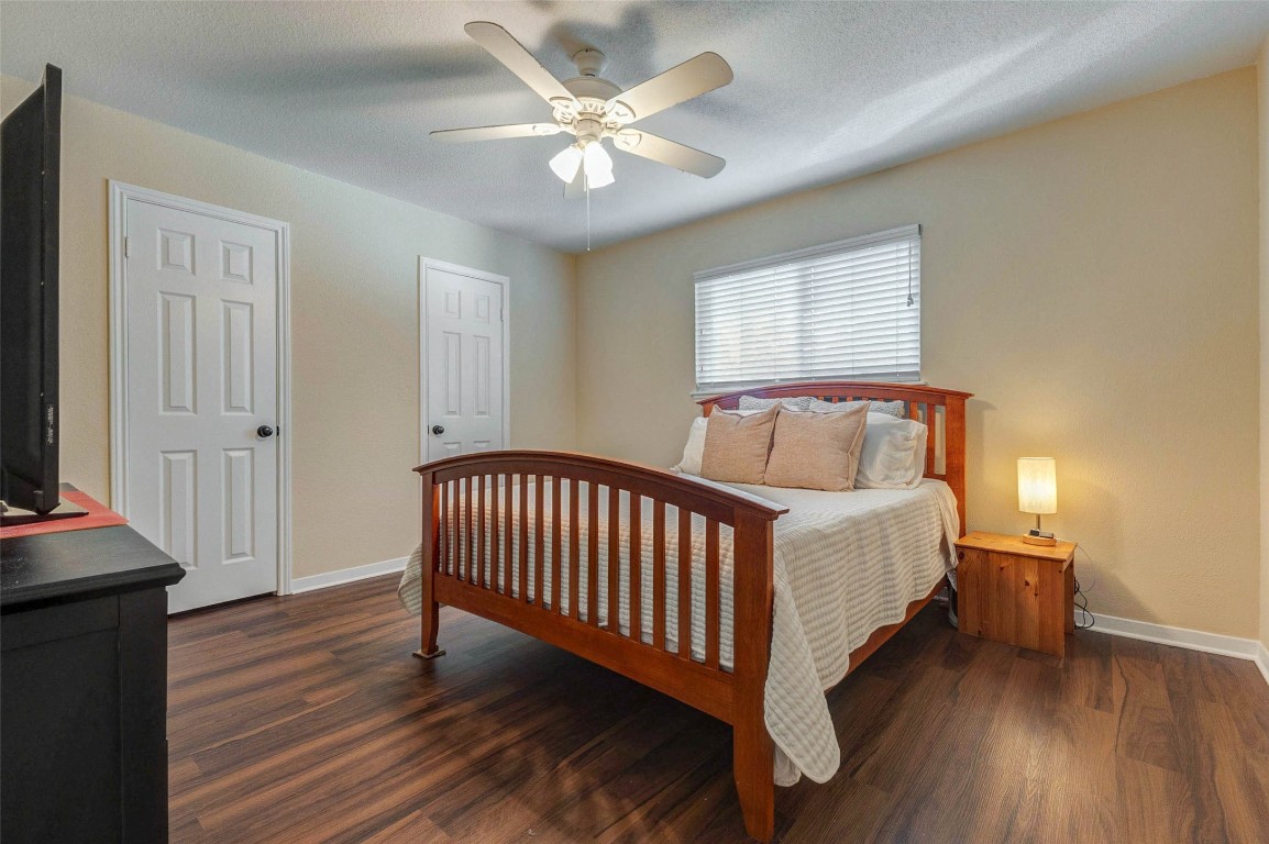 6710 Falling Waters Drive Spring, TX 77379 - Photo 28 of 45 This cozy bedroom features hardwood floors, a ceiling fan, and a large window that lets in natural light.