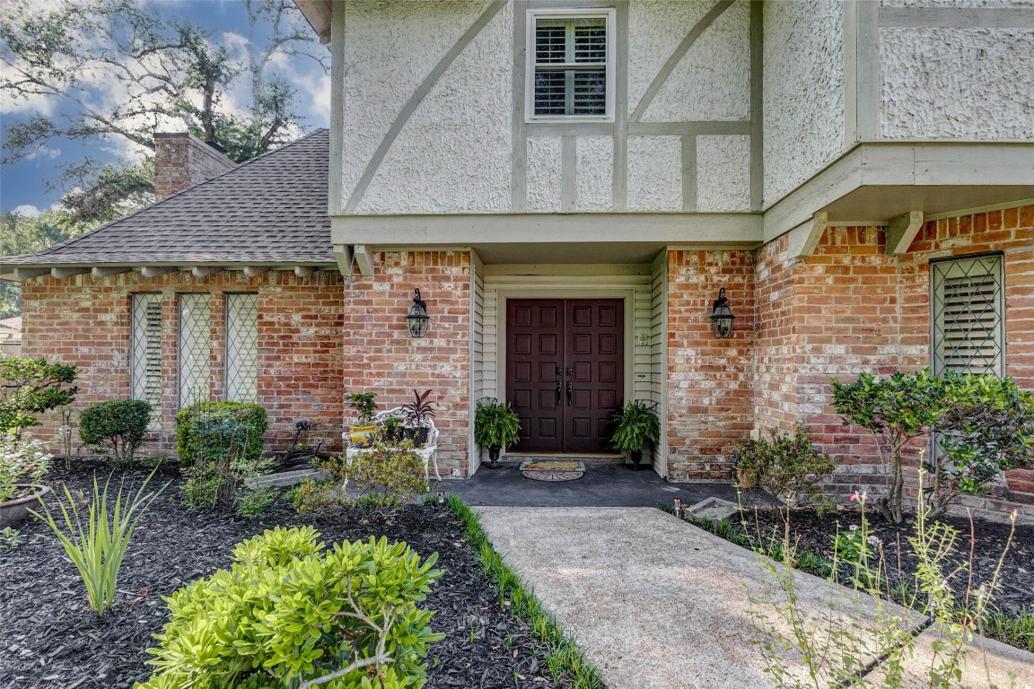 6710 Falling Waters Drive Spring, TX 77379 - Photo 3 of 45 The entryway is inviting, with double doors, a porch, and landscaping.