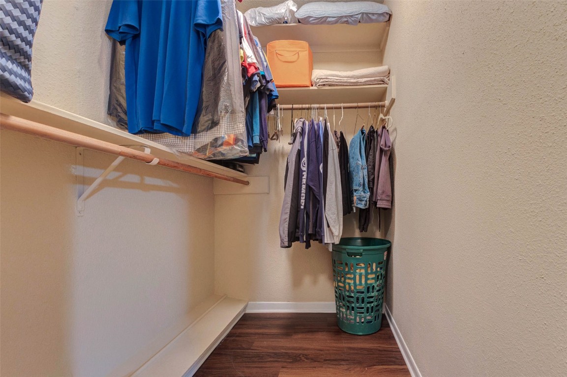 6710 Falling Waters Drive Spring, TX 77379 - Photo 36 of 45 The primary suite has a spacious walk-in closet with ample shelving and hanging space, ideal for organized storage.