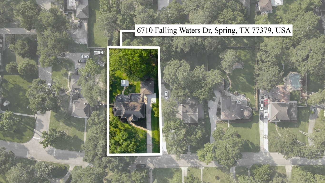 6710 Falling Waters Drive Spring, TX 77379 - Photo 4 of 45 Excellent residential property at 6710 Falling Waters Dr, Spring, TX. It highlights a spacious home surrounded by lush greenery in a well-established neighborhood, offering a serene and private setting.