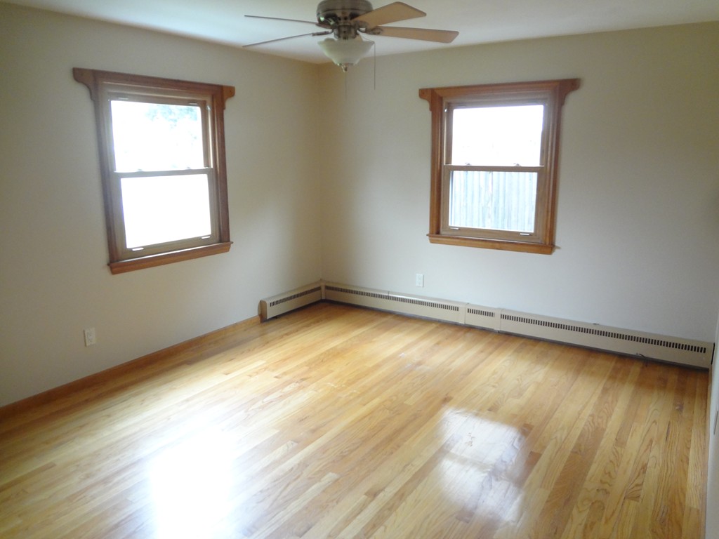 27 Bennington Street Springfield, MA 01108 - Photo 11 of 20 a view of an empty room with a window and wooden floor