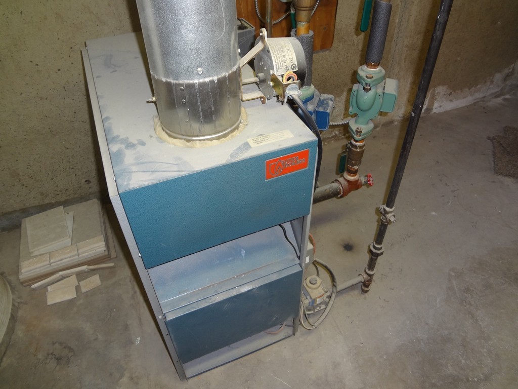 27 Bennington Street Springfield, MA 01108 - Photo 16 of 20 a room with water heater and washing machine
