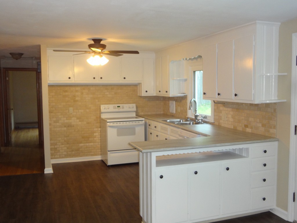 27 Bennington Street Springfield, MA 01108 - Photo 2 of 20 a kitchen with cabinets and wooden floor