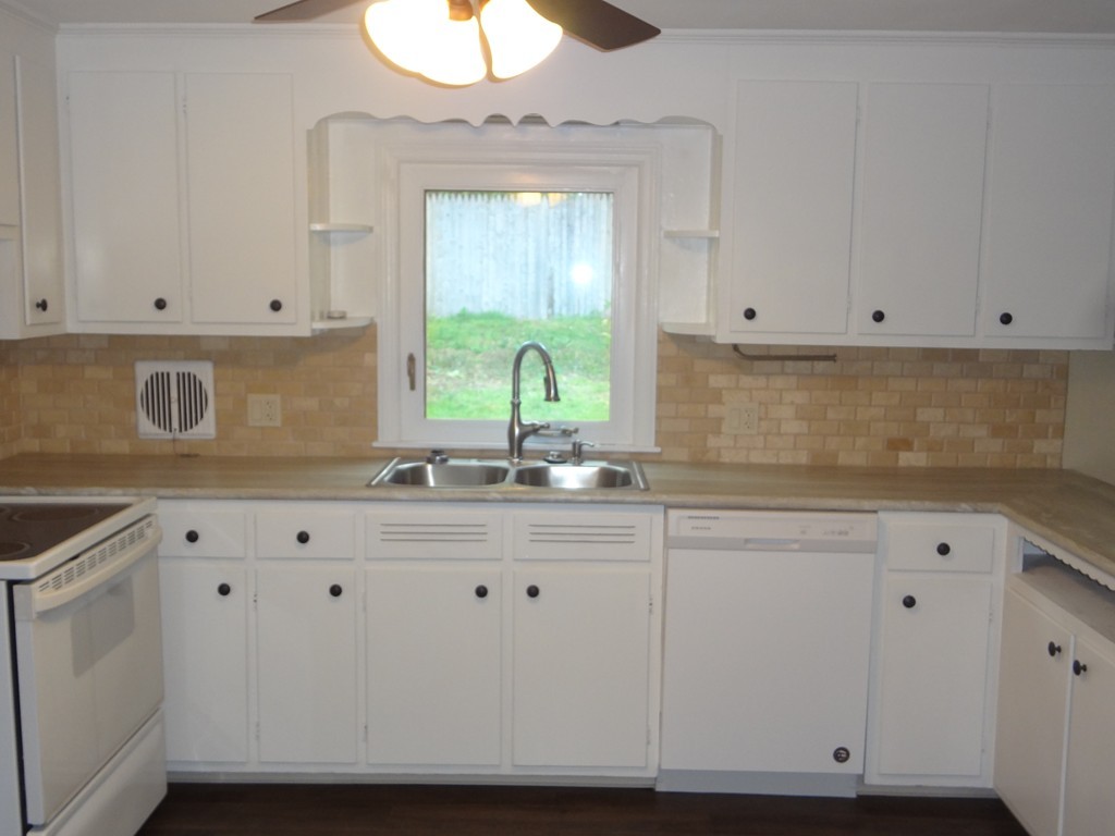 27 Bennington Street Springfield, MA 01108 - Photo 3 of 20 a kitchen with granite countertop white cabinets and sink