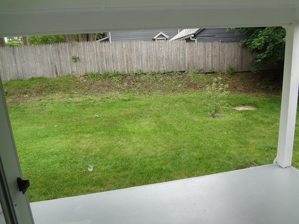27 Bennington Street Springfield, MA 01108 - Photo 5 of 20 a view of a backyard with wooden fence