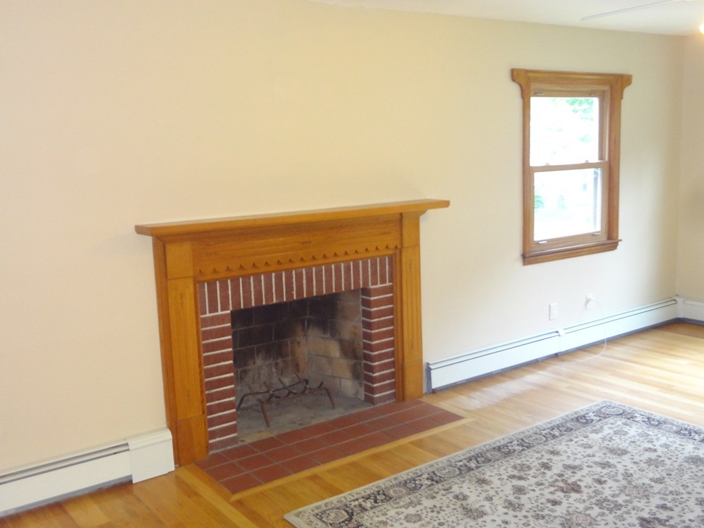 27 Bennington Street Springfield, MA 01108 - Photo 7 of 20 a living room with a fireplace