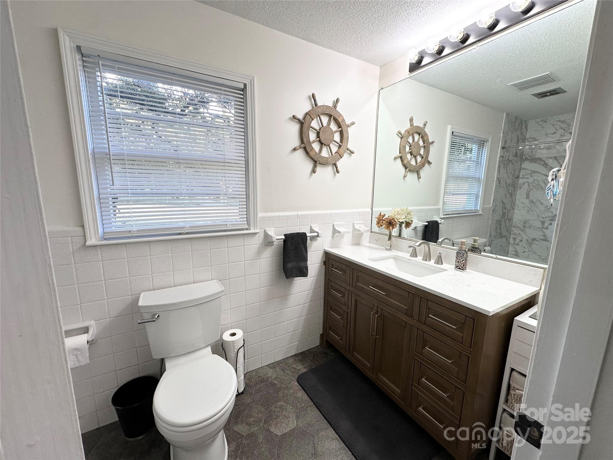 400 Charles Street Spencer, NC 28159 - Photo 20 of 26 a bathroom with a toilet sink and mirror