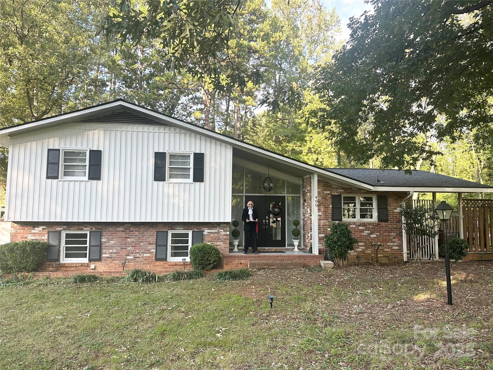 400 Charles Street Spencer, NC 28159 - Photo 2 of 26 a front view of a house with a garden