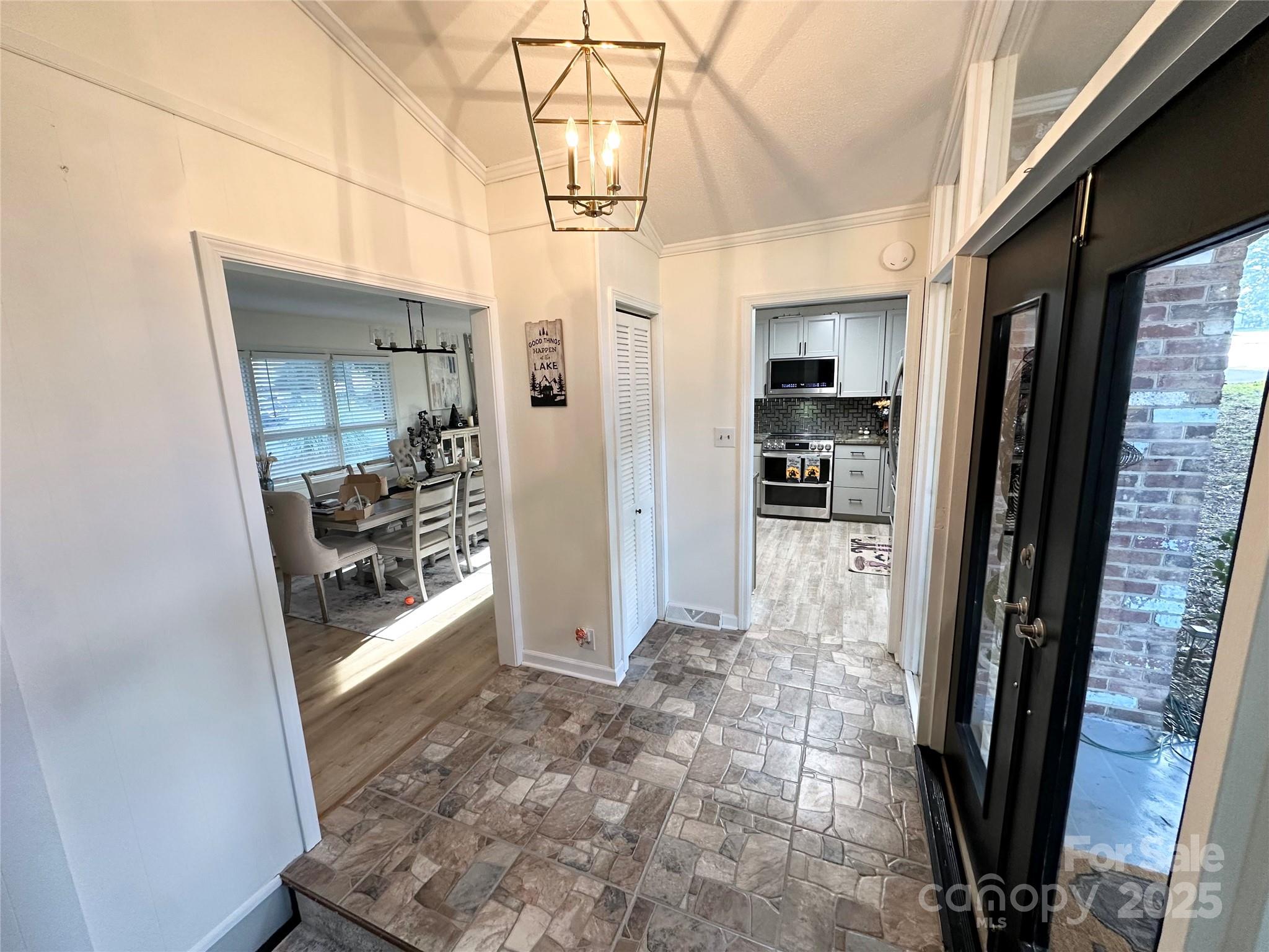 400 Charles Street Spencer, NC 28159 - Photo 6 of 26 a view of a hallway with a dining table and a refrigerator