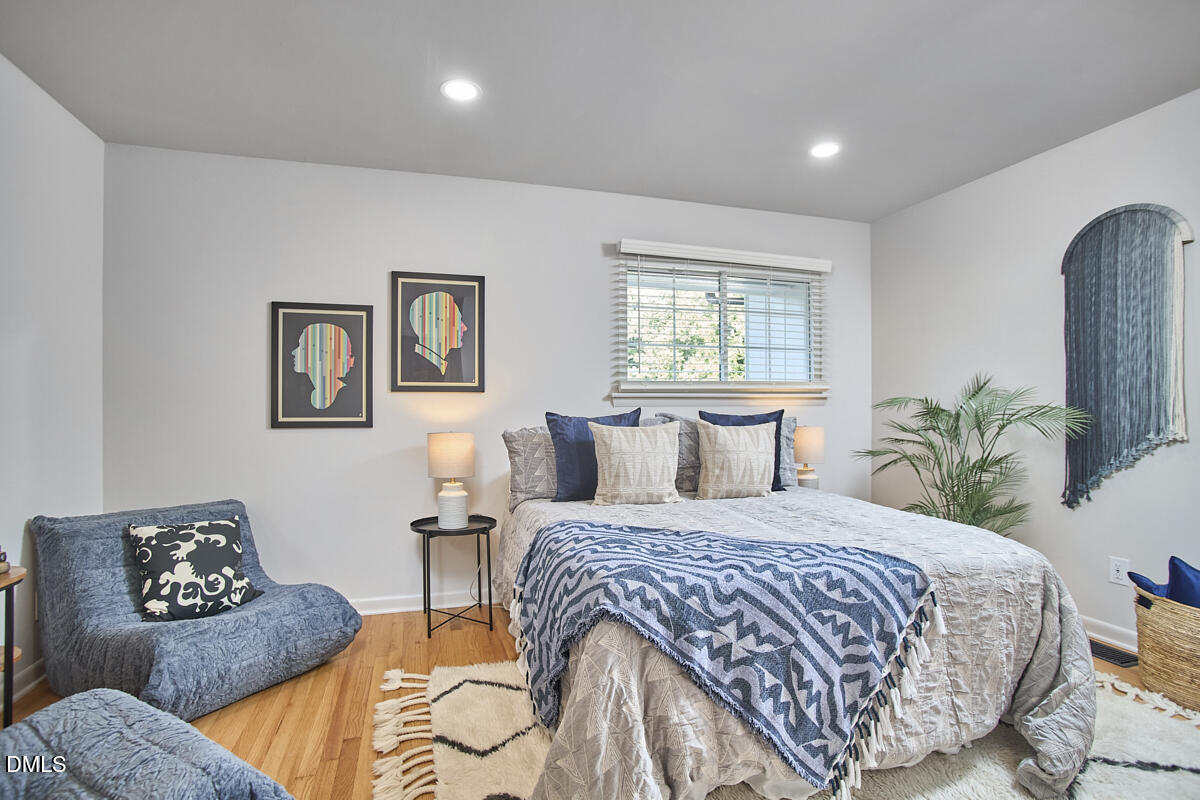 2613 McNeil Street, Unit B Raleigh, NC 27608 - Photo 27 of 31 a bedroom with double bed and a couch