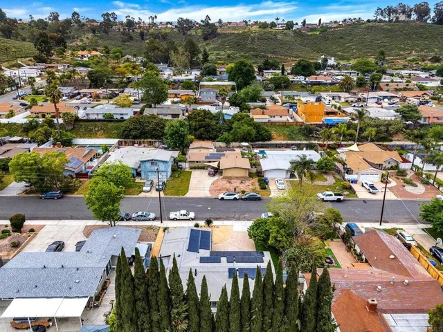 a large white kitchen with a large window