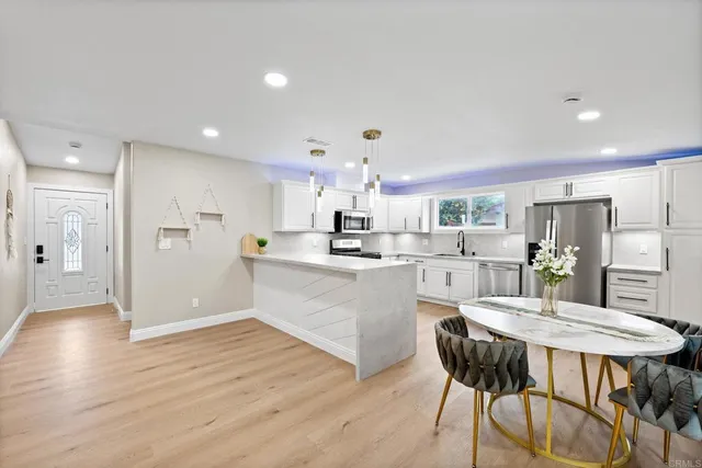 a large kitchen with stainless steel appliances kitchen island granite countertop a sink and cabinets