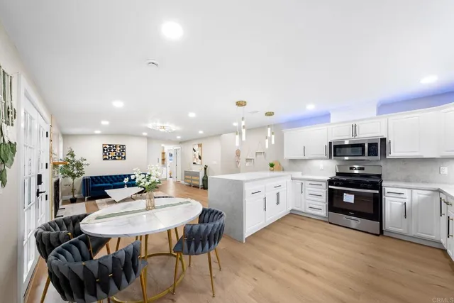 a large white kitchen with a large window