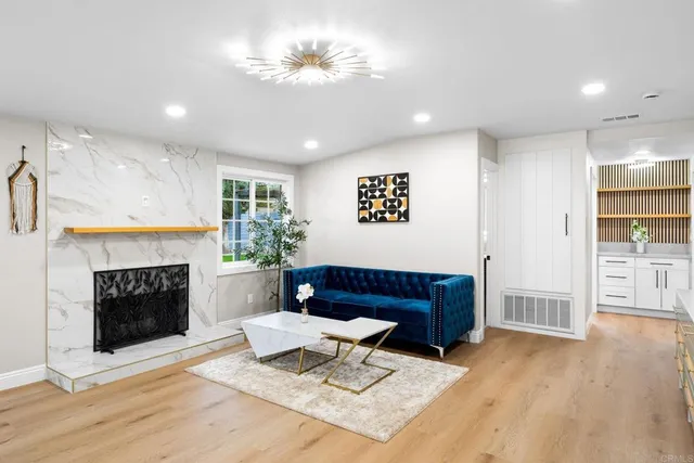 a living room with furniture and a chandelier