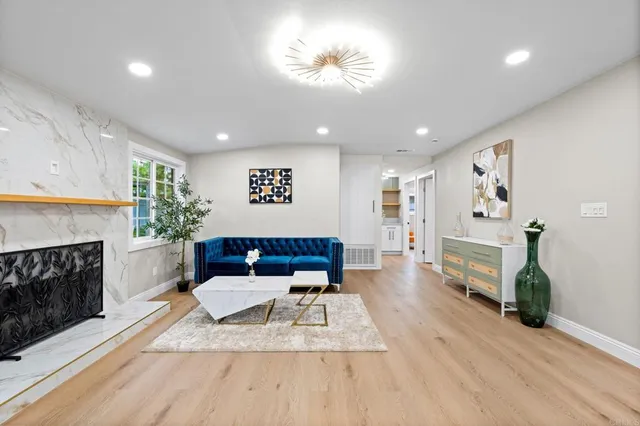 a living room with furniture and a fireplace
