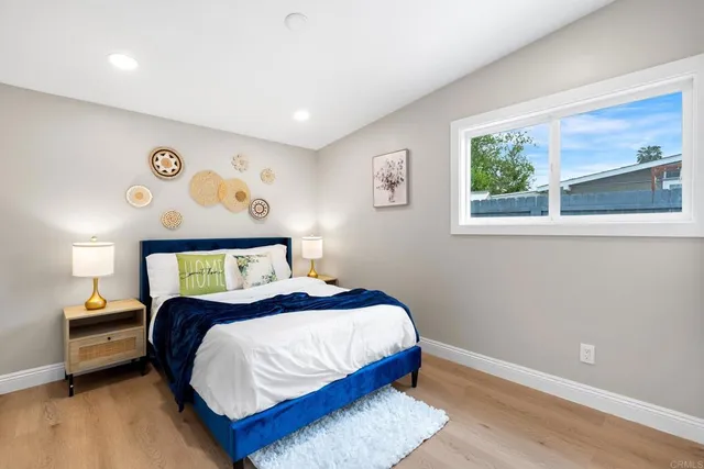 a bedroom with a bed and a night stand