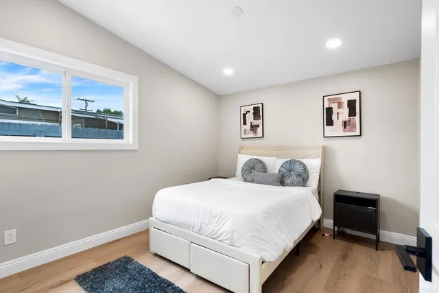 a bedroom with a bed and blue couch