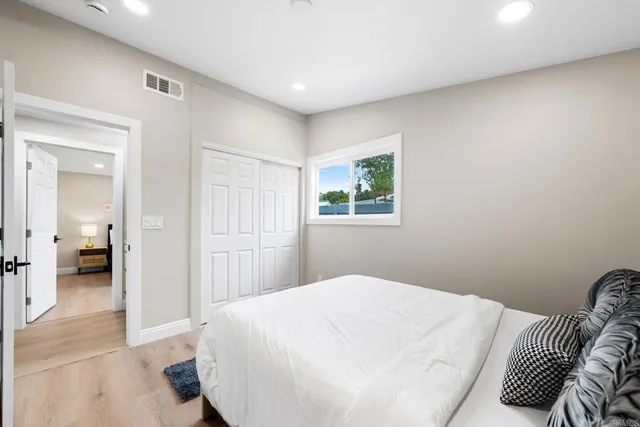 a bedroom with a bed and a painting on the wall