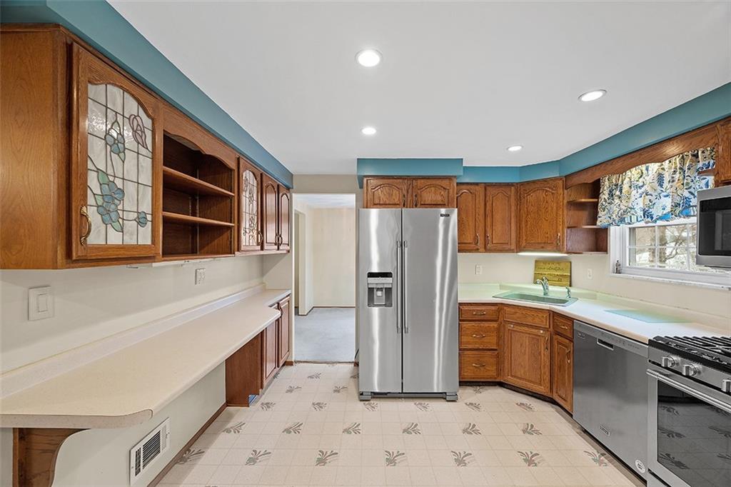 515 Braddock Road Pittsburgh, PA 15221 - Photo 12 of 38 a kitchen with a refrigerator and a sink