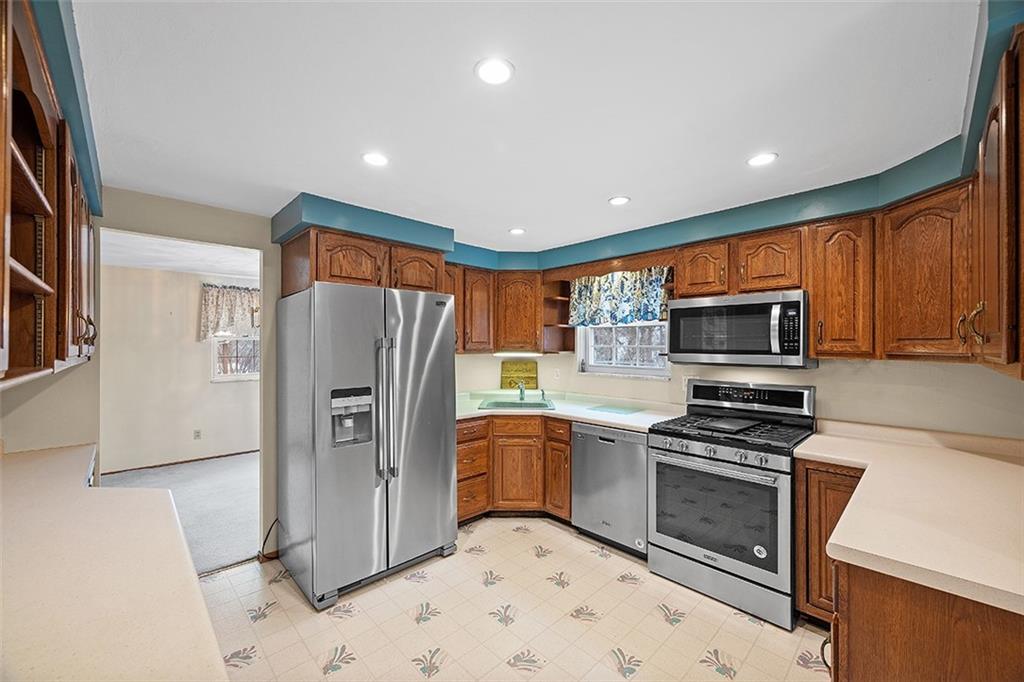 515 Braddock Road Pittsburgh, PA 15221 - Photo 13 of 38 a kitchen with stainless steel appliances granite countertop a refrigerator stove and sink