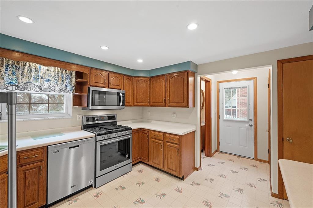 515 Braddock Road Pittsburgh, PA 15221 - Photo 14 of 38 a kitchen with stainless steel appliances granite countertop a stove a sink and a refrigerator