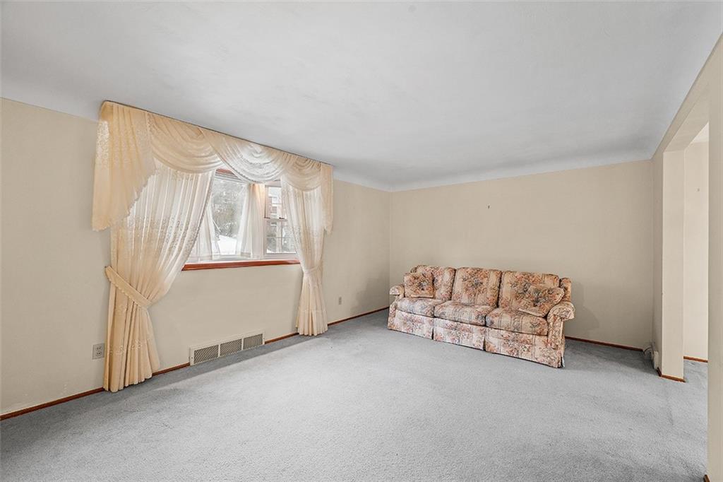 515 Braddock Road Pittsburgh, PA 15221 - Photo 8 of 38 a living room with furniture and a window