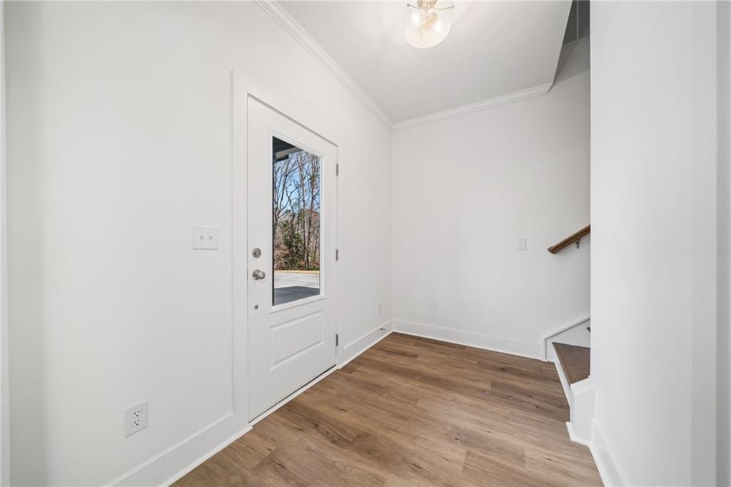 518 Old Canton Road Ball Ground, GA 30107 - Photo 13 of 42 a view of an empty room with wooden floor and a window