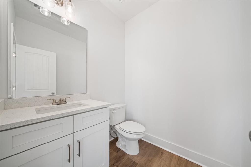 518 Old Canton Road Ball Ground, GA 30107 - Photo 15 of 42 a bathroom with a toilet a sink and mirror