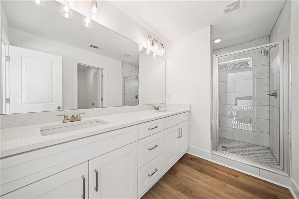 518 Old Canton Road Ball Ground, GA 30107 - Photo 17 of 42 a bathroom with double sink and a mirror