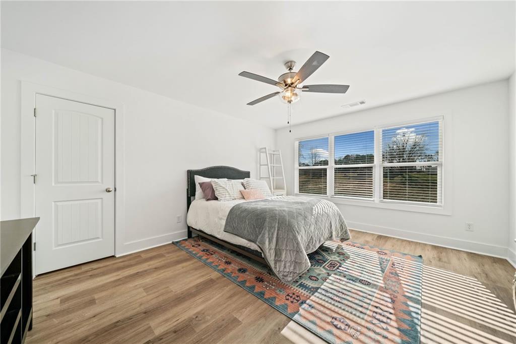 518 Old Canton Road Ball Ground, GA 30107 - Photo 18 of 42 a spacious bedroom with a bed and a window